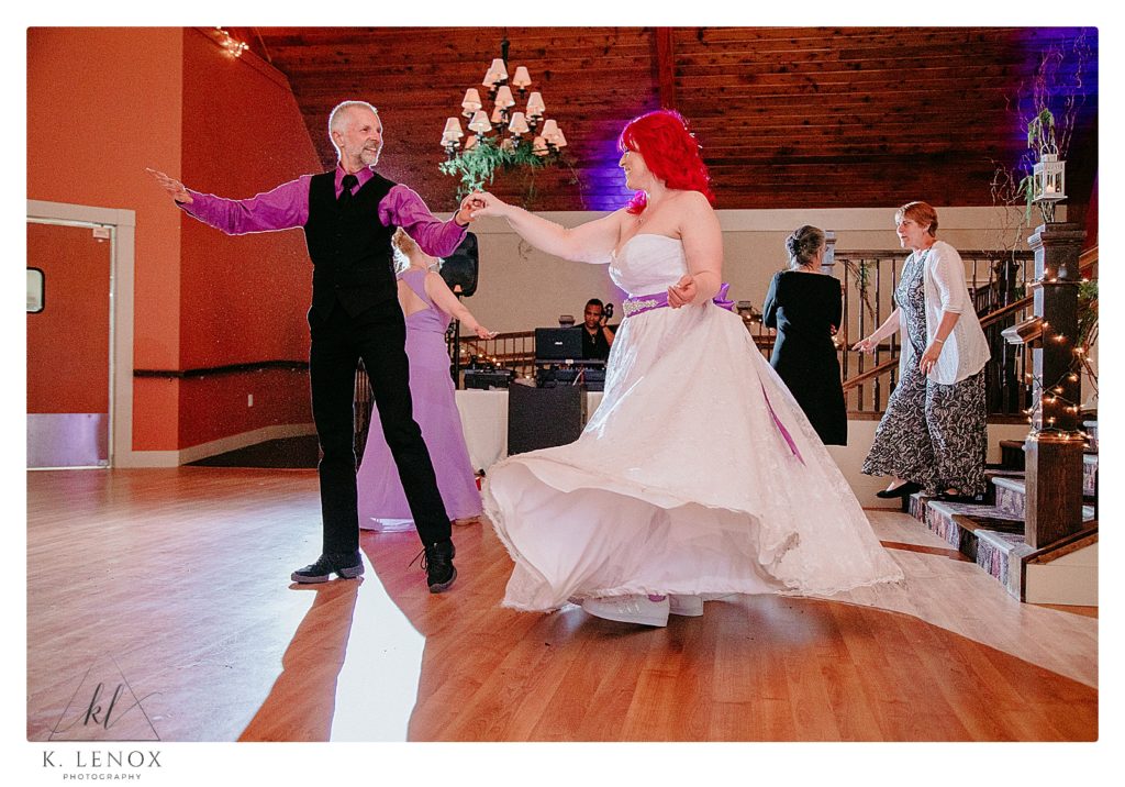 Wedding Reception at the Shattuck Golf Club in Jaffrey nh.  Bride and a friend dance as her dress twirls. 