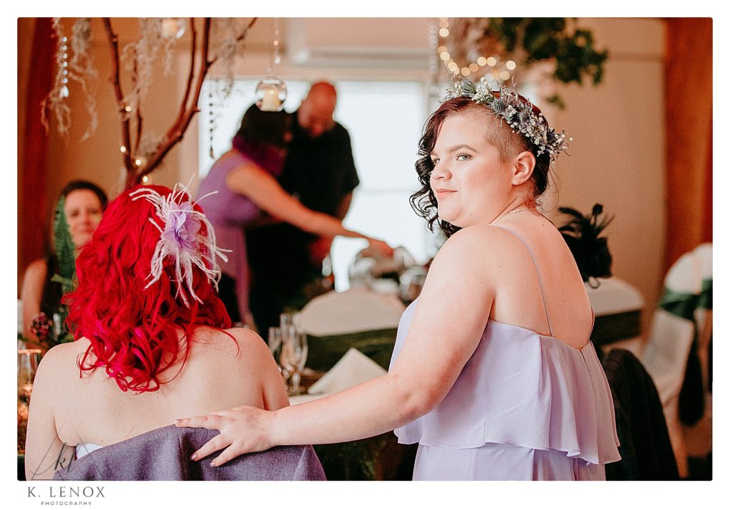 Candid photo of a bridesmaid during a wedding reception at the Shattuck Golf Course in Jaffrey. 