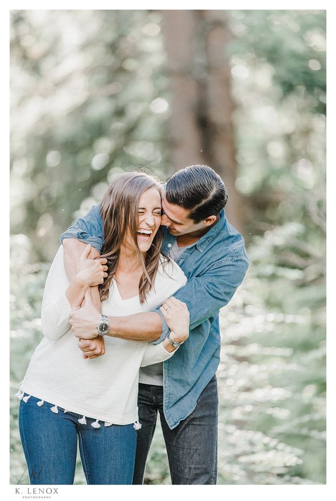Casual and Natural photo of a man and woman wearing jeans from an Engagement session at Benson Park in NH. 