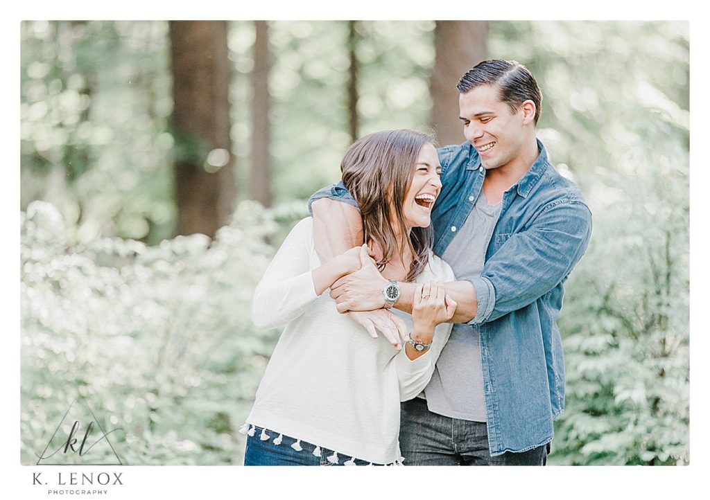 Candid photos from a Light and Airy Engagement Session in Benson Park NH with Kara and Guy.  A couple wearing jeans and white shirts. 