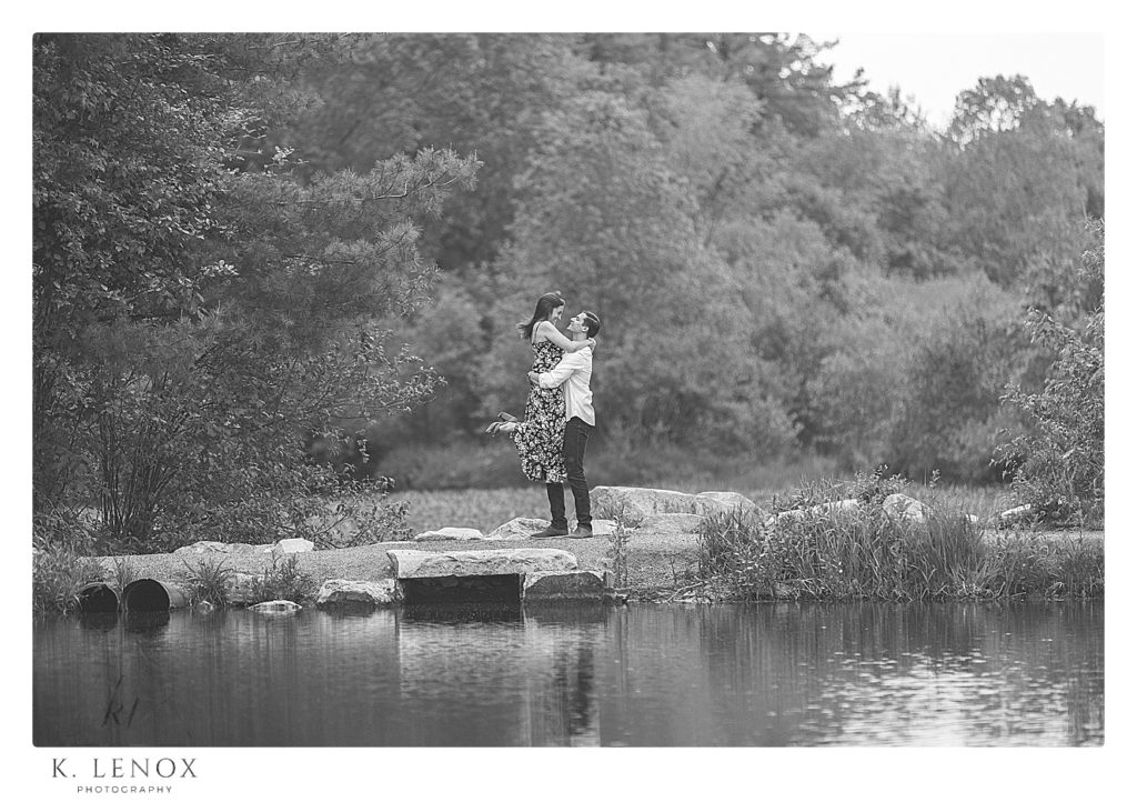Black and White candid photo of an engaged couple in Benson Park in NH.  Photo by K. Lenox Photography