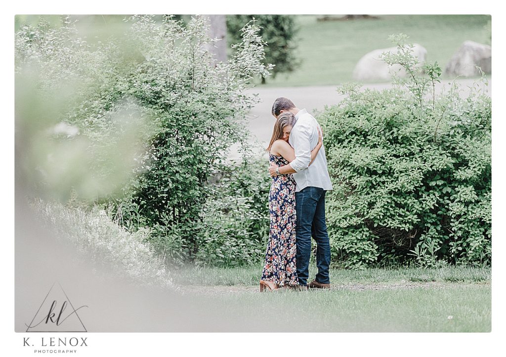 Engaged couple hug after having an emotional conversation at Benson Park during their photo session with K. Lenox Photography