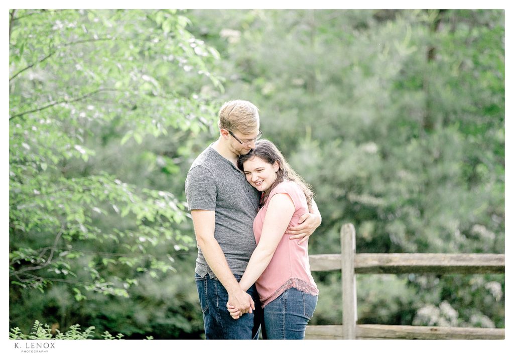 Light and Airy Engagement session Photo showing a man and woman holding hands  and hugging.   