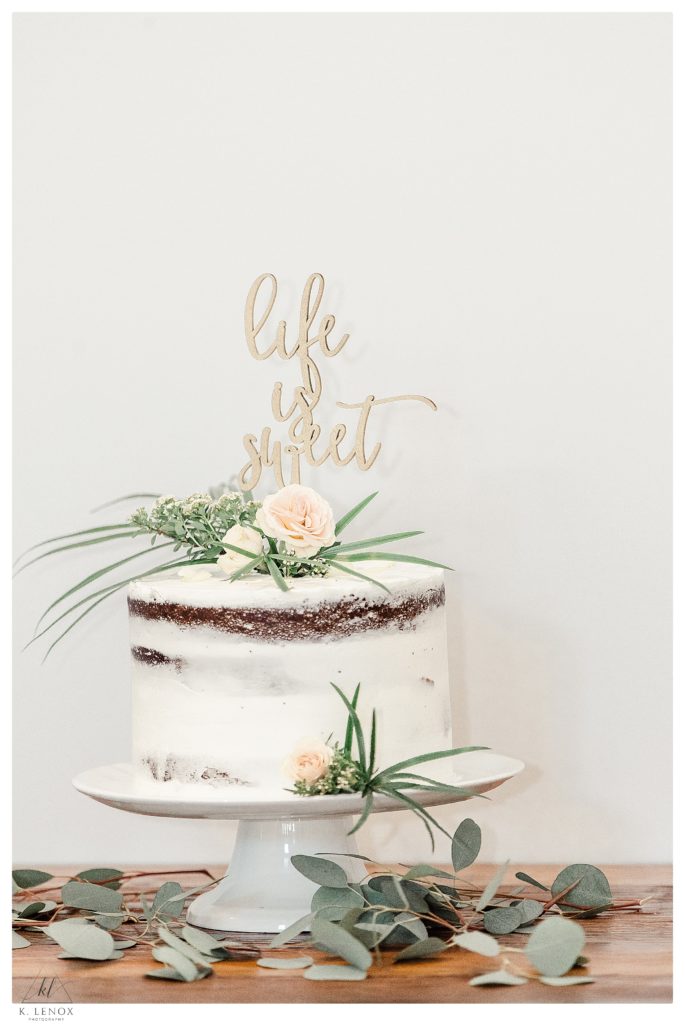 Interior Reception Decor for a Mayfair Farm Wedding- Showing white naked cake with a "life is sweet" cake topper. 