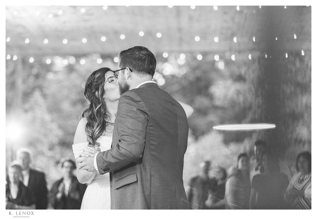 Black and White photo of a bride and groom having their first dance on the covered porch of Mayfair farm. 