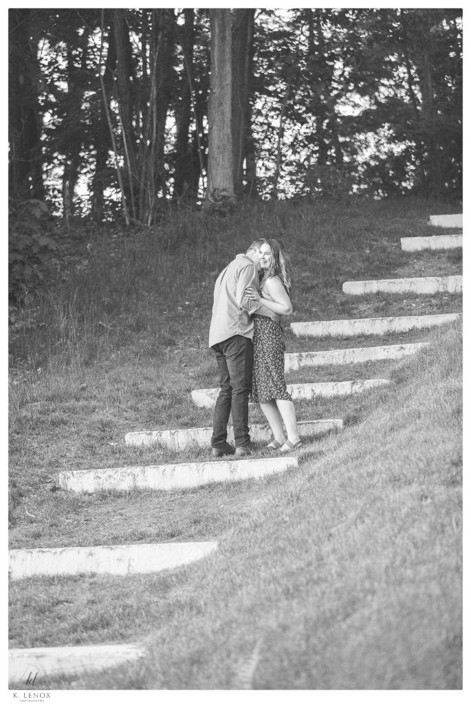 Black and White Photo of a Man and woman climbing an outdoor set of stairs. 