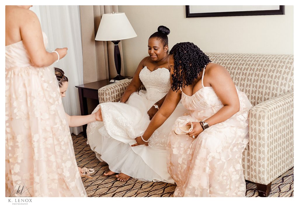 Bride and her bridesmaids getting their shoes on. 
