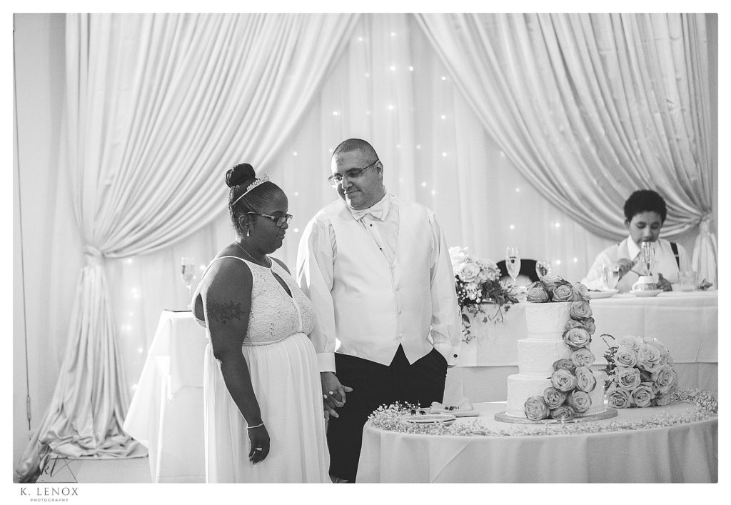 Bride and Groom get ready to cut the cake at their Classic Wedding at Alpine Grove in NH. 