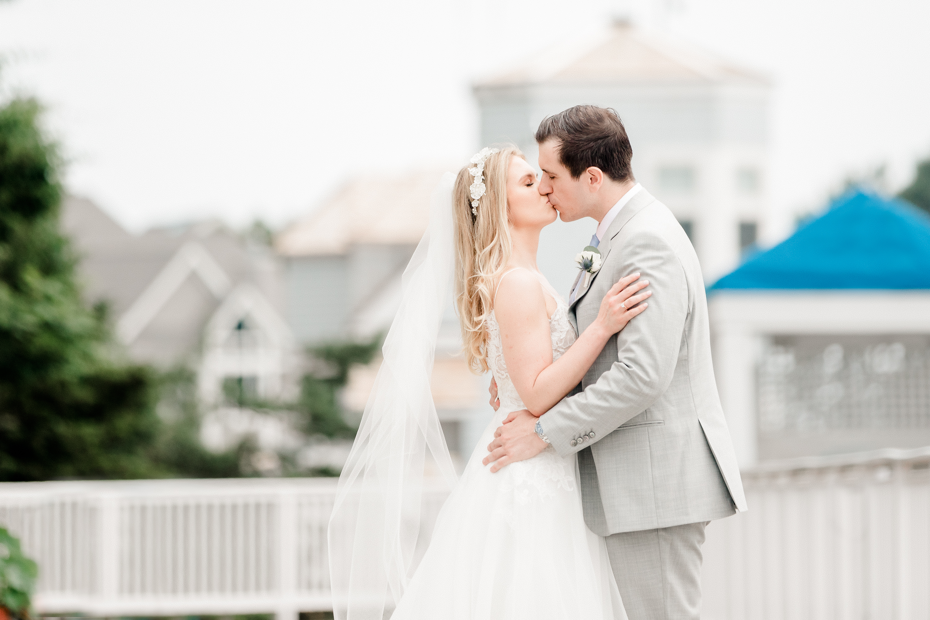 Bride and Groom kiss on the dock at the Wentworth by the Sea