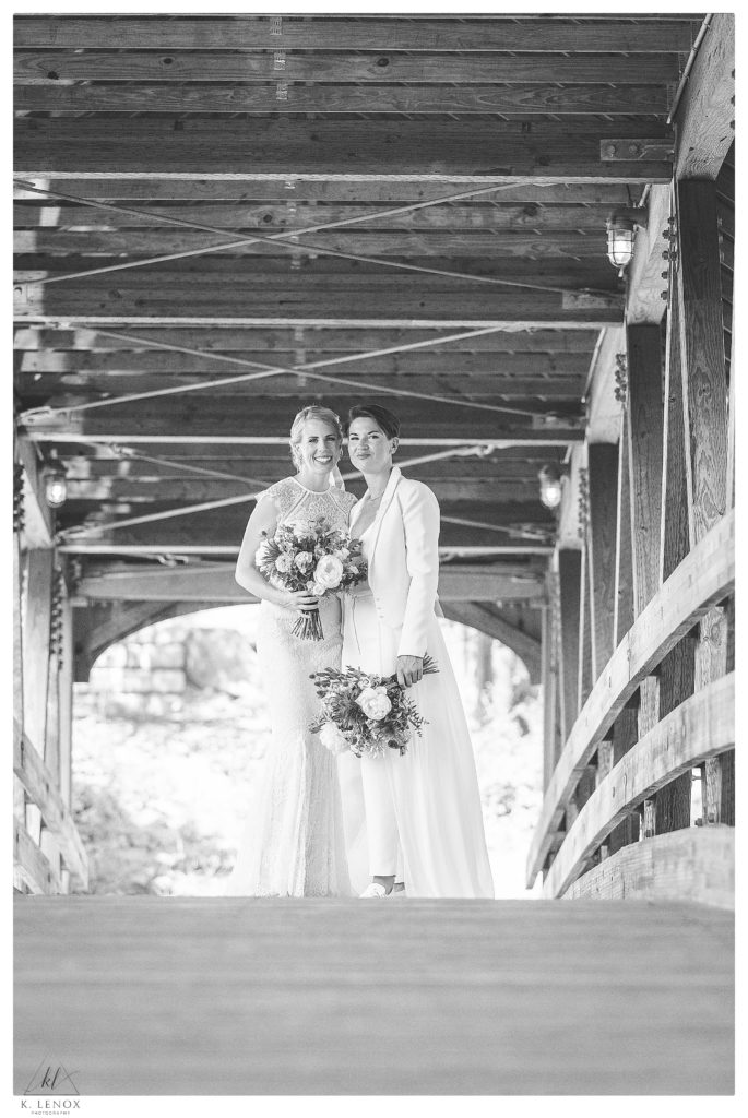 Black and White photo showing two brides on a covered bride near Mount  Sunapee