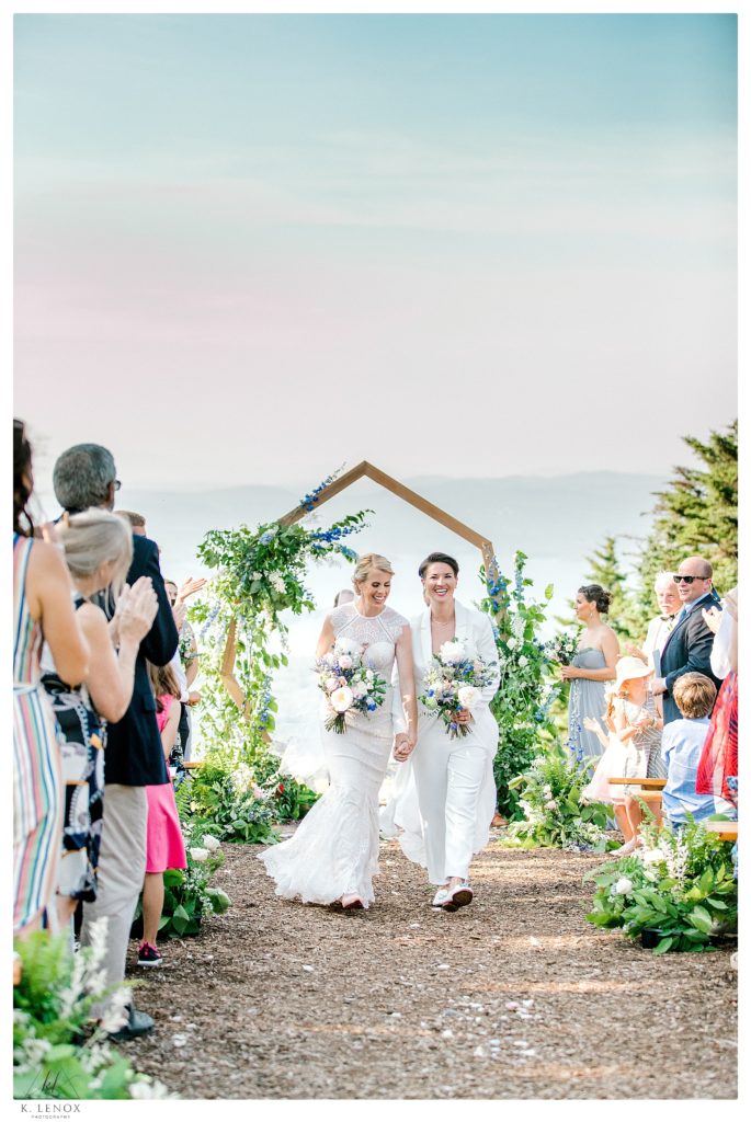 Summer Wedding ceremony at Mount Sunapee.  Recess back down the aisle after saying . "i do" . 