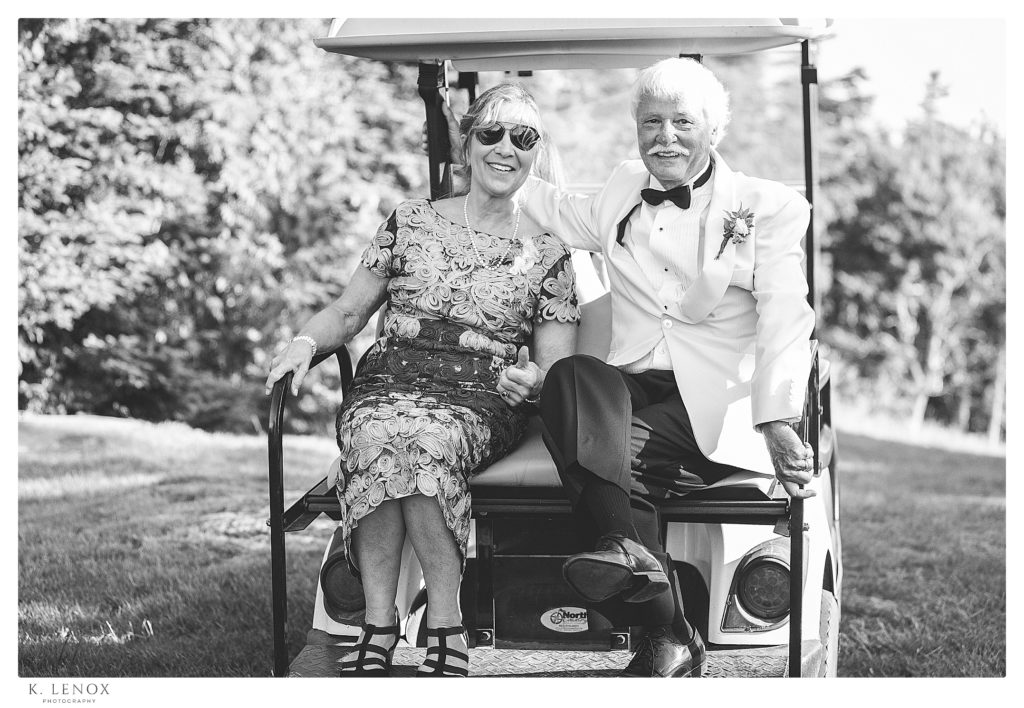 Parents of one of the brides- Hop on to the back of a golf cart.  Black and White photo. 