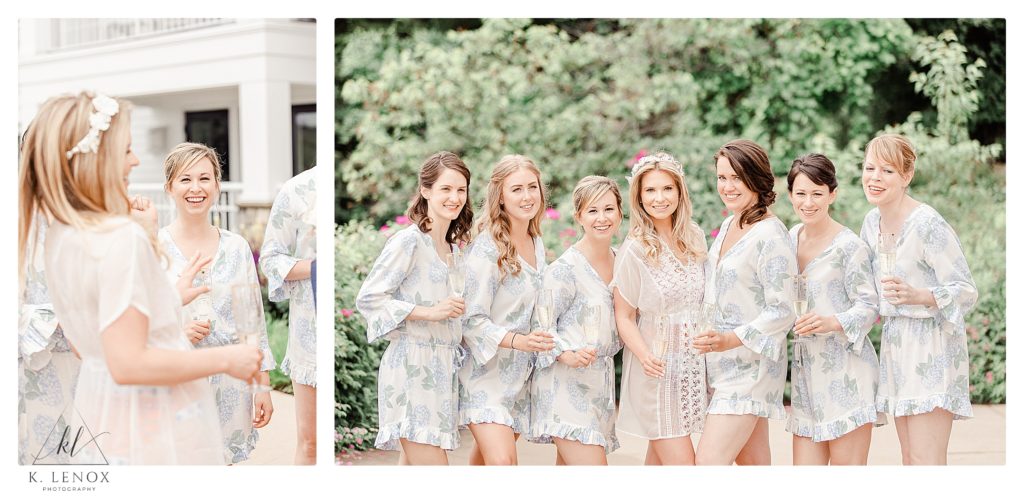Bride and Bridesmaids pose for a portrait while wearing light floral silk robes holding champagne 