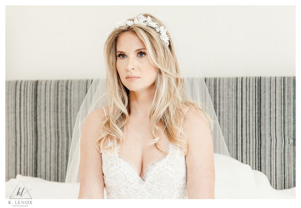 Beautiful blonde haired bride wearing a floral hairpiece and a veil.  Light and Airy photo by K. Lenox Photography