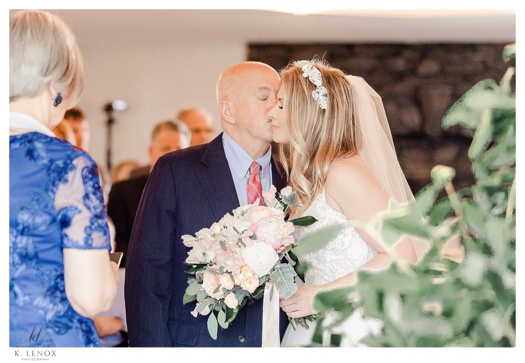 Dad gives bride away during an indoor wedding ceremony at the York Golf and Tennis Club. 