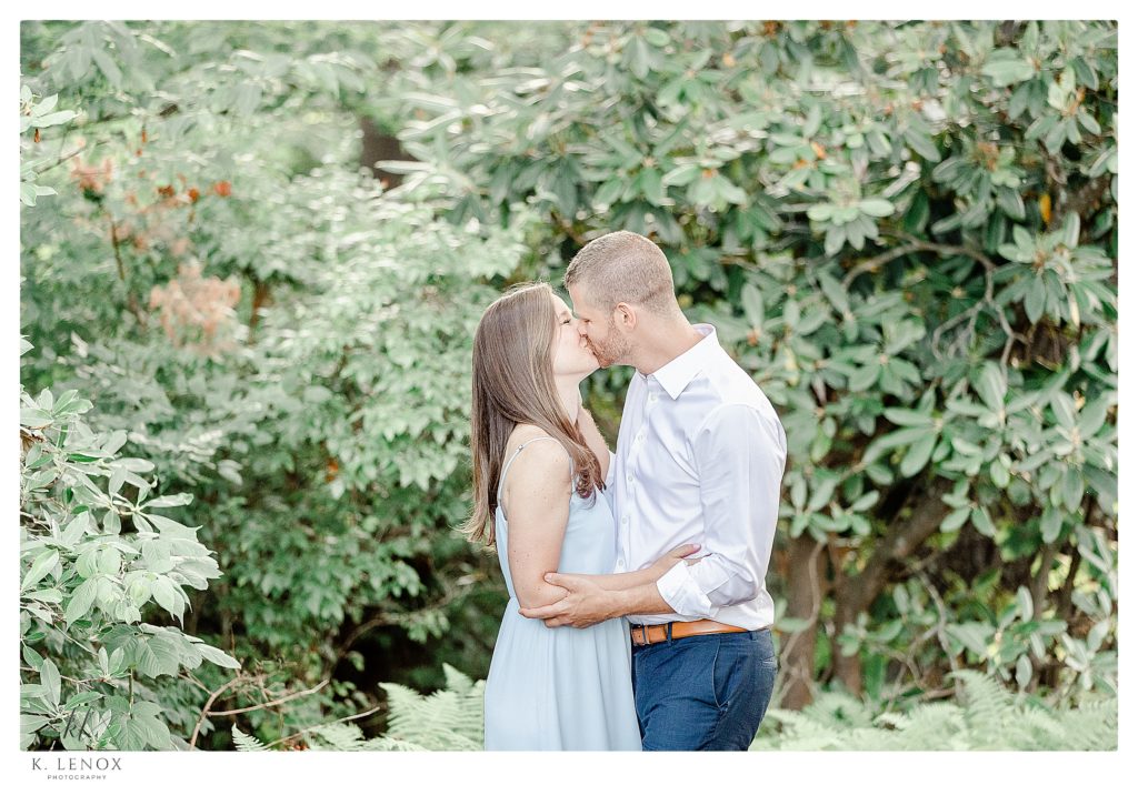 Light and Airy photo showing a man and woman kissing during their engagement session 