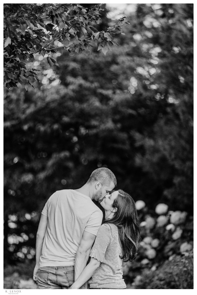 Black and White Photo of a Man and woman kissing during their engagement session 