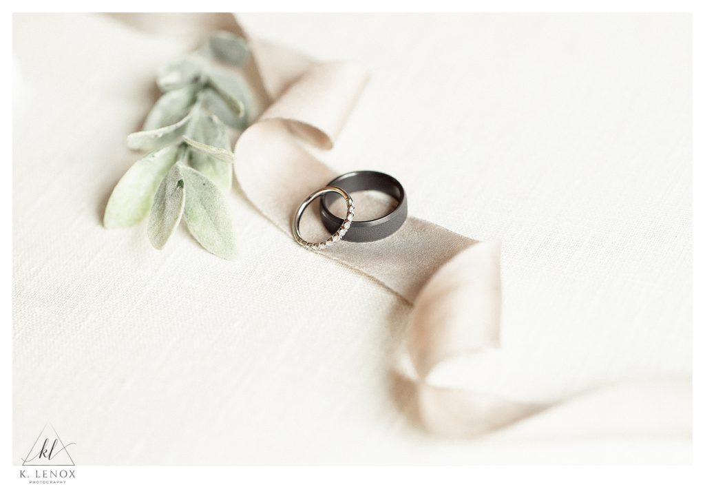 Light and Airy detail photo showing two wedding bands on a strand of ribbon. 