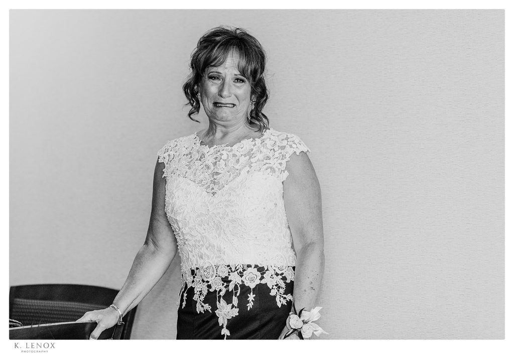 Candid black and white photo of a woman crying on her son's wedding day at Birchwood Vineyard. 