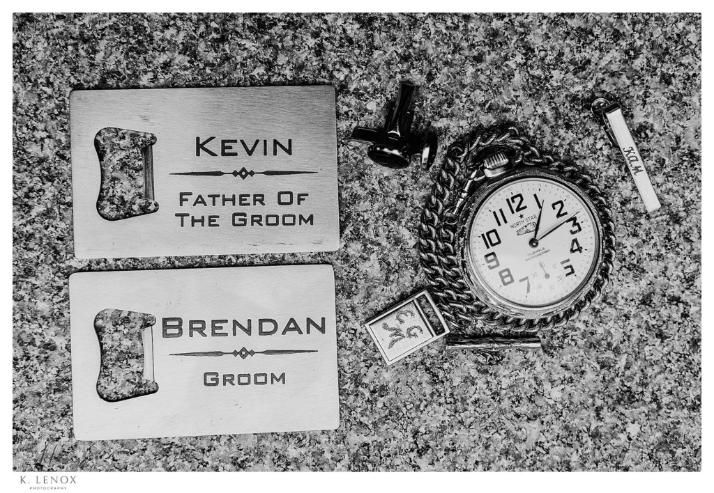 Black and White photos of the Groom's details.  A pocket watch and customized "man cards". 