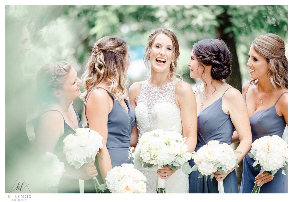Light and Airy photo of a Bride and her 5 bridesmaids wearing antique blue dresses in Varying styles. 