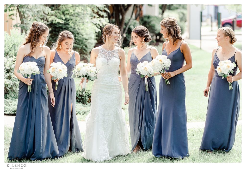 Light and Airy photo of a Bride and her 5 bridesmaids wearing antique blue dresses in Varying styles. 