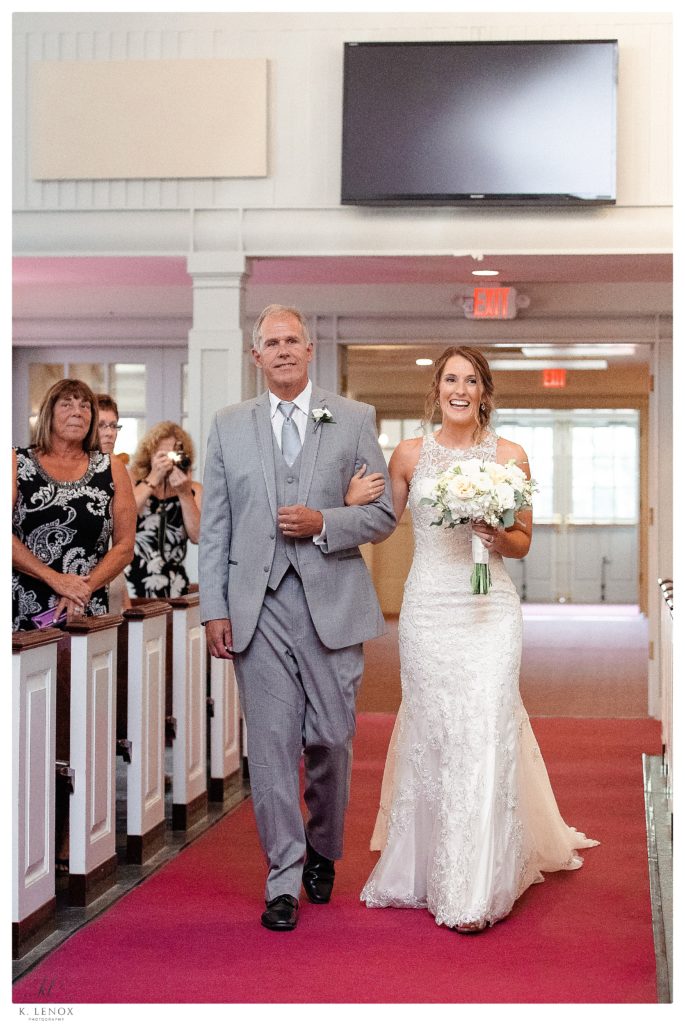 Bride walks down the aisle at the Bethany Covenant Church in Bedford NH. 