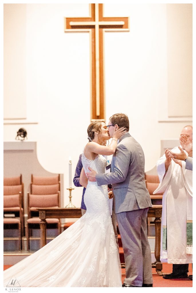 Summer Wedding at the Bethany Covenant Church in Bedford NH.   photo of the ceremony during the first kiss.  