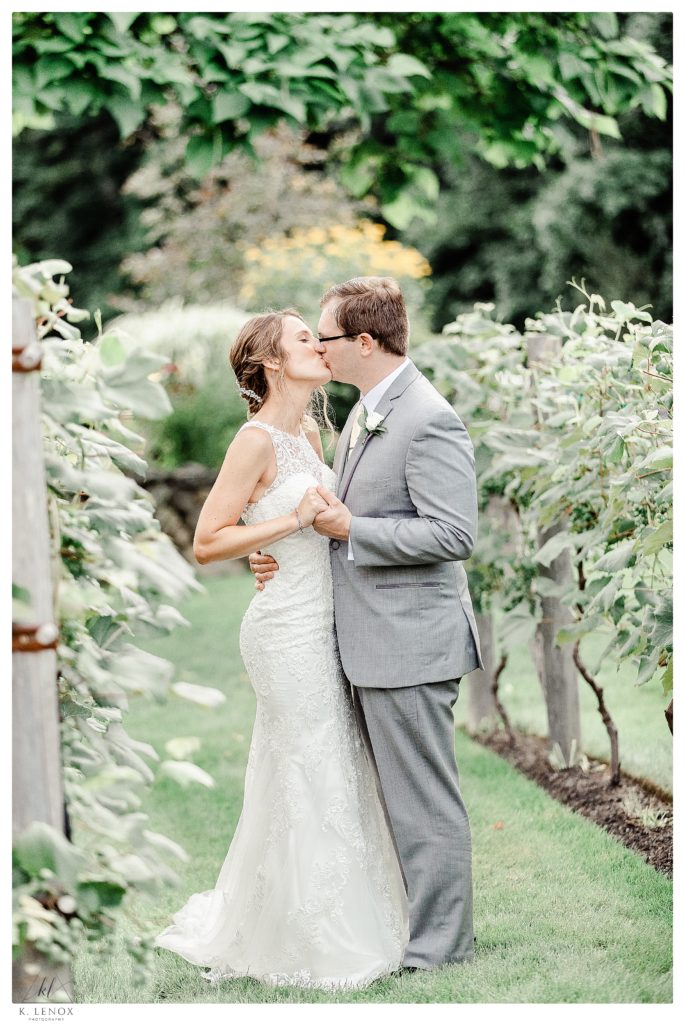 A candid photo of a bride and Groom kissing during their Summer Wedding at Birch Wood Vineyard 