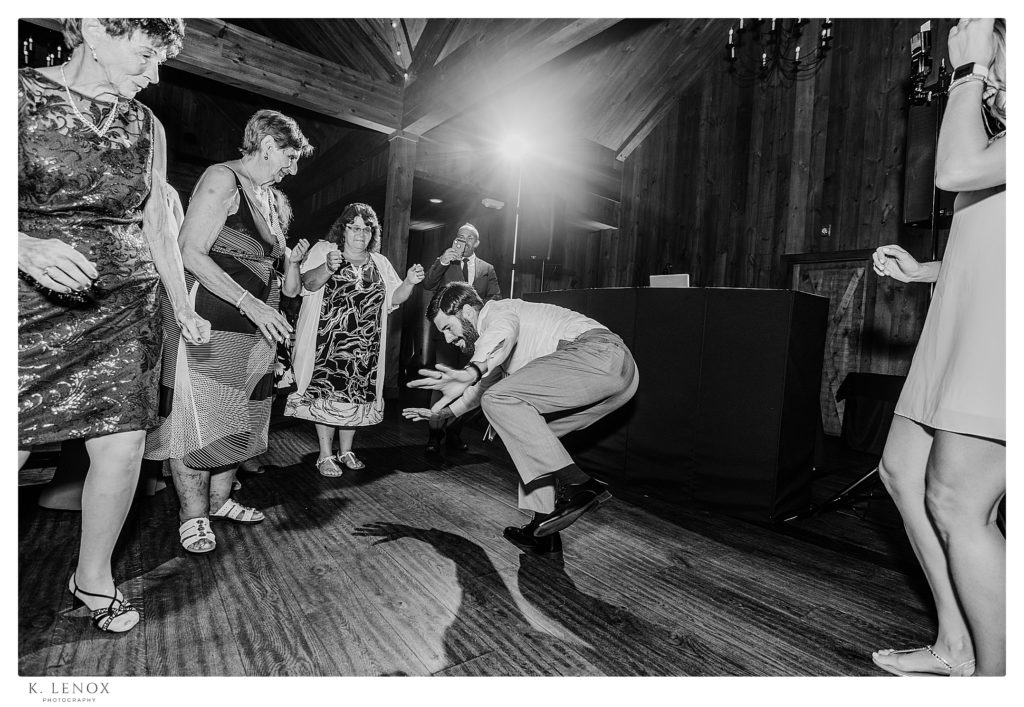 Black and White Candid photo showing people dancing a Summer Wedding Reception at the Birch Wood Vineyard in Bedford NH.