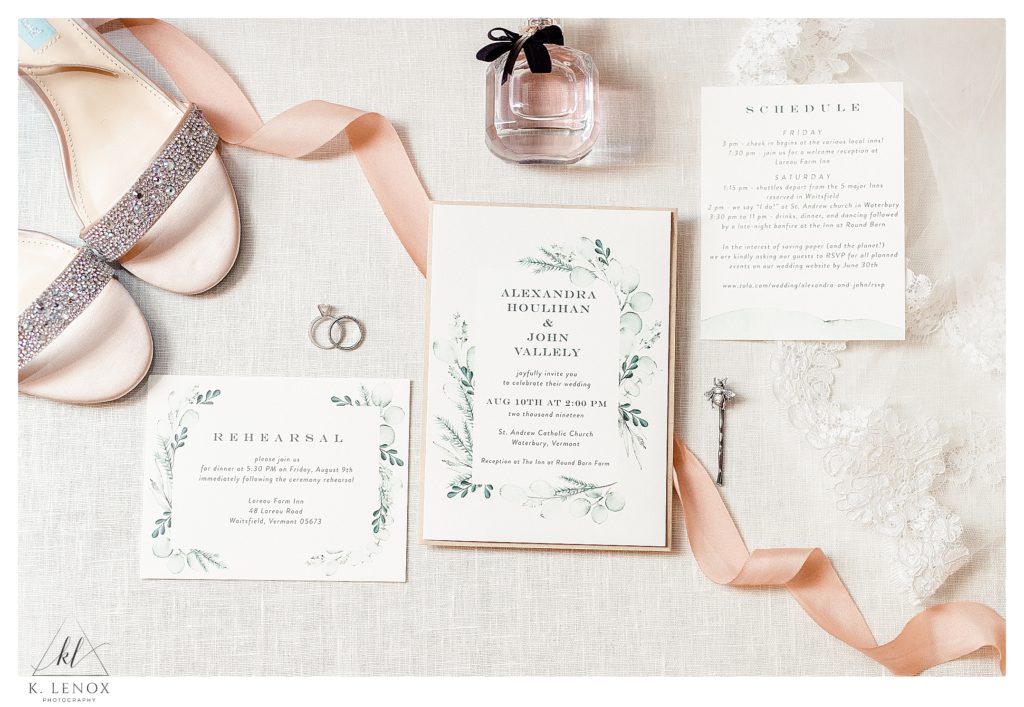 Stylized flat lay showing a variety of Bridal Details for a wedding day.  Light and airy- tones of pink.  White invitation, pink ribbon, 