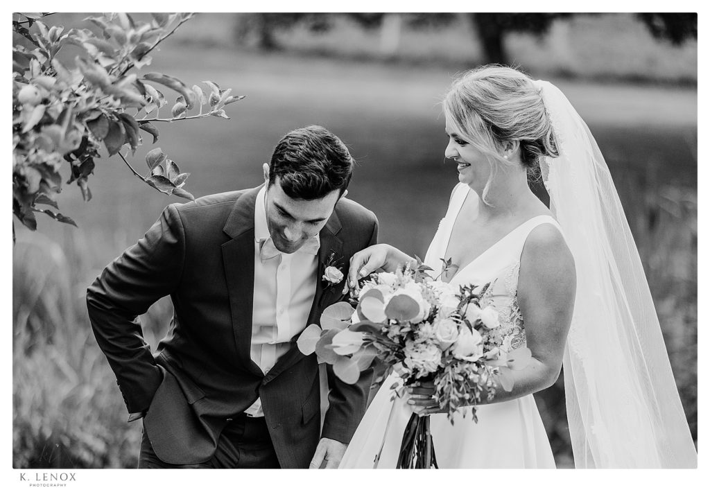 Candid and Photojournalistic black and white photo of a bride and groom laughing on their wedding day! 
