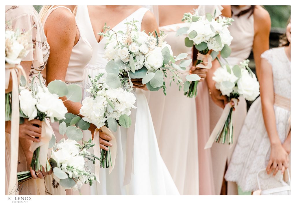 light and Airy photos showing bride's bouquet with Bridal Bouquet: A front held ribbon tied bouquet of hydrangea,
garden rose, ranunculi, eucalyptus, veronica, dusty miller and garden texture. 
