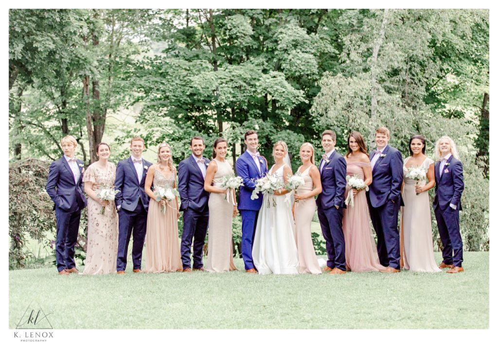 Entire wedding party photo showing the groomsmen and the Bridesmaids at the Inn at the round barn. 