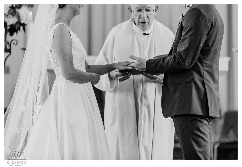 Black and White photo of a Bride and Groom exchanging rings