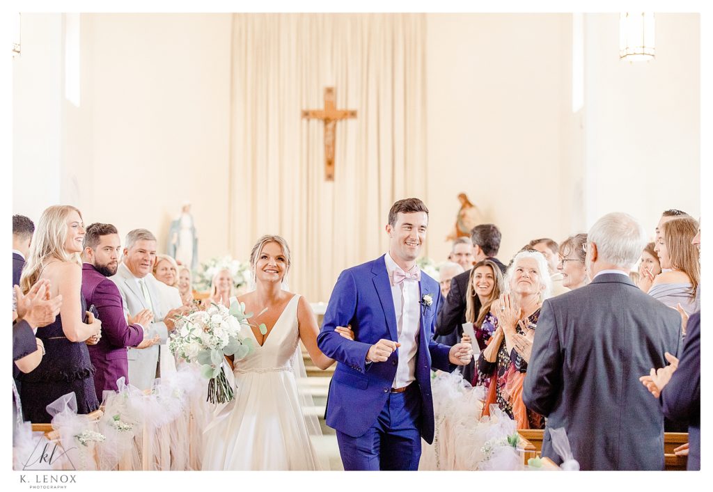 Bride and Groom dance down the aisle after their wedding cermony