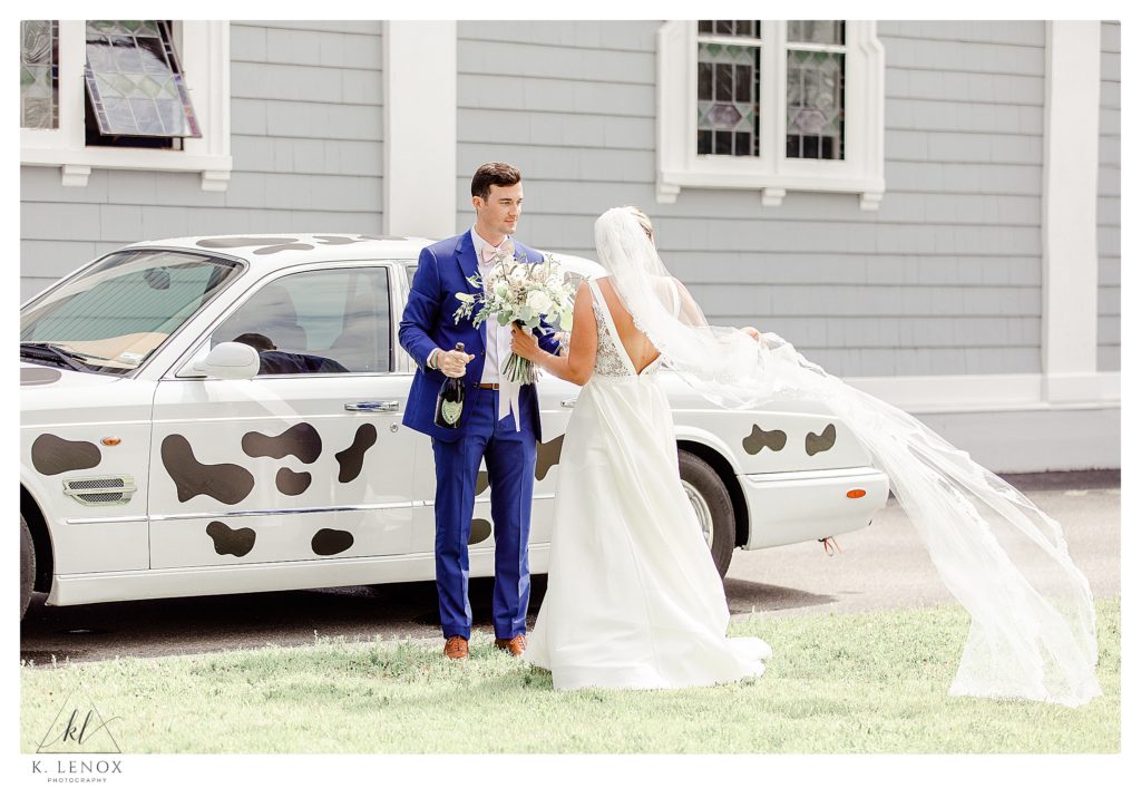 Bride and Groom prepare to have a toast in front of the Bentley right after they were married!  