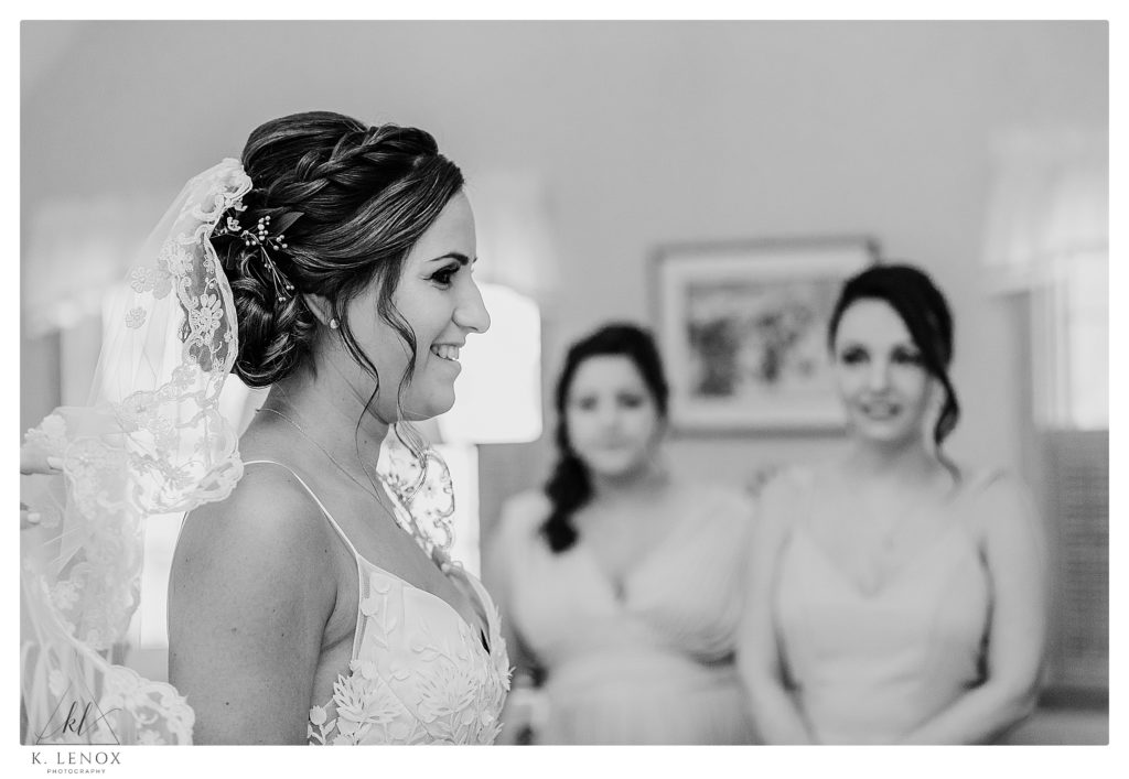 Black and White photo showing a bride wearing a veil getting ready for her Wedding at The West Mountain Inn