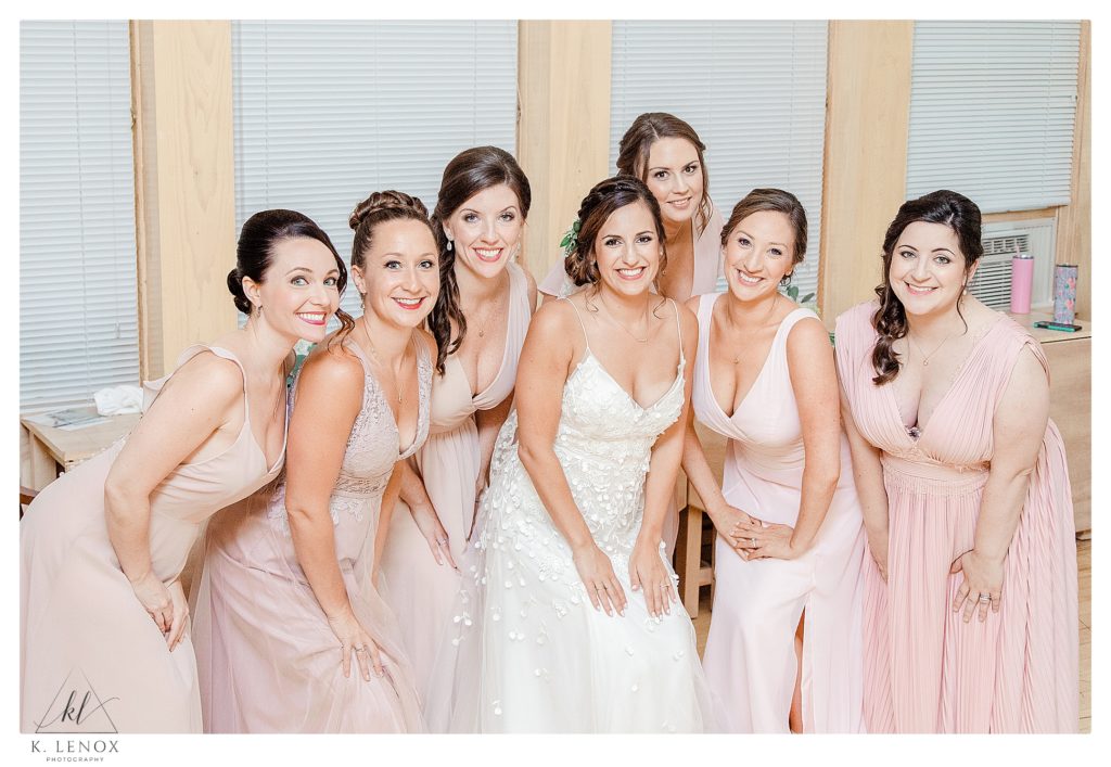 A bride and her six bridesmaids pose for a portrait in the bridal suite at The West Mountain Inn in Arlington VT. 