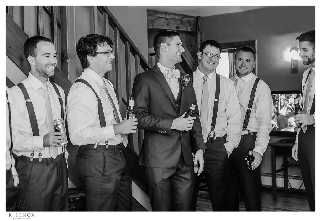 Black and White photo of a Groom hangs out drinking a beer before his Wedding at The West Mountain Inn