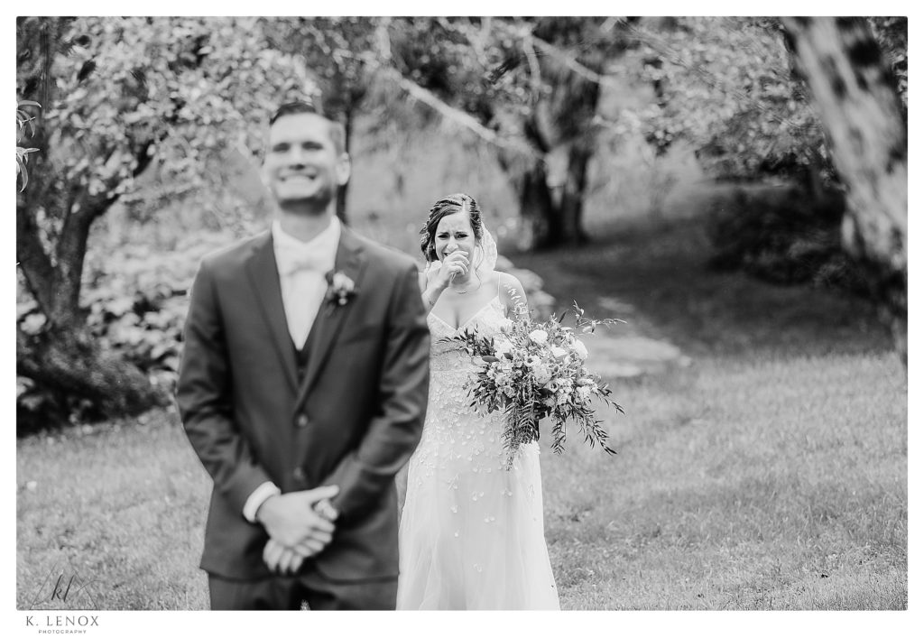 Black and White photo showing a bride's facial expression just before her groom sees her at the West Mountain Inn in Arlington Vt. 