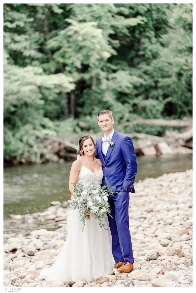 Formal photo of a Bride and Groom on their wedding day, next to the river near the West Mountain inn. 