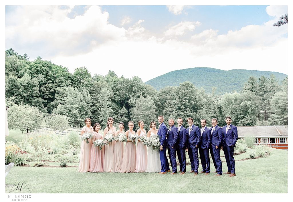 Entire wedding party posing for a formal portrait at the West Mountain Inn