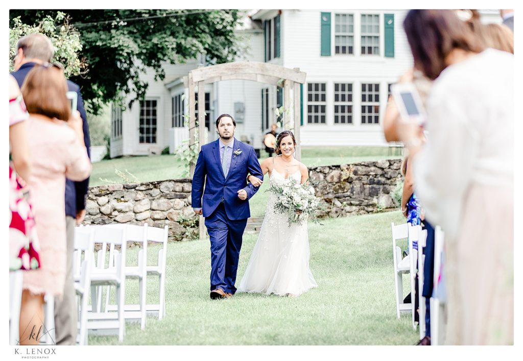 Bride walks down the aisle for her wedding at the West Mountain Inn. 