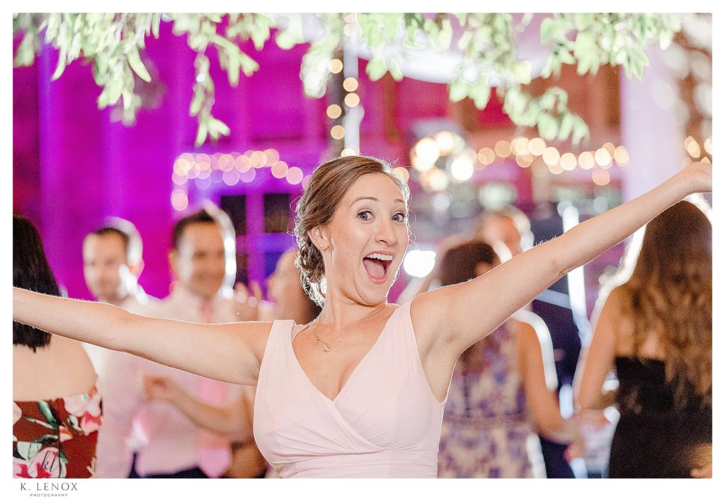 Bridesmaid gives the camera a silly smile during a wedding reception at the West Mountain Inn. 