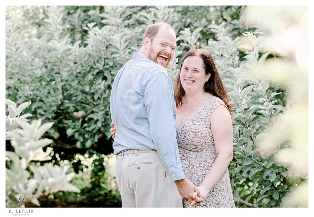 Man and Woman, dressed with business casual attire have their Engagement Session at Alyson's Orchard