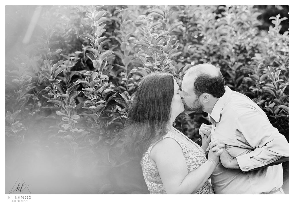 Black and White photo of a man and woman having their Engagement Session at Alyson's Orchard