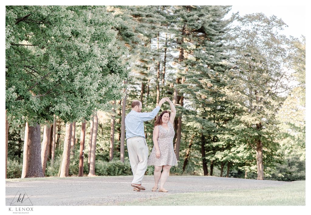 Light and Airy Engagement Session at Alyson's Orchard- showing a man and woman twirling. 