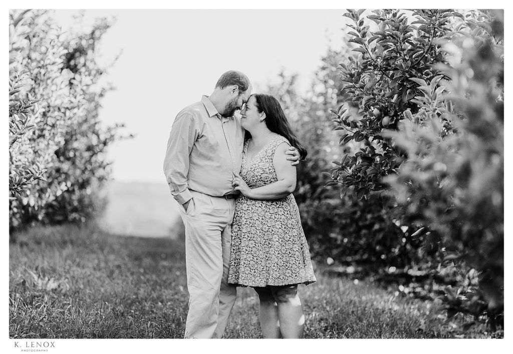 Black and White Engagement Session at Alyson's Orchard showing a man and woman looking at each other. 