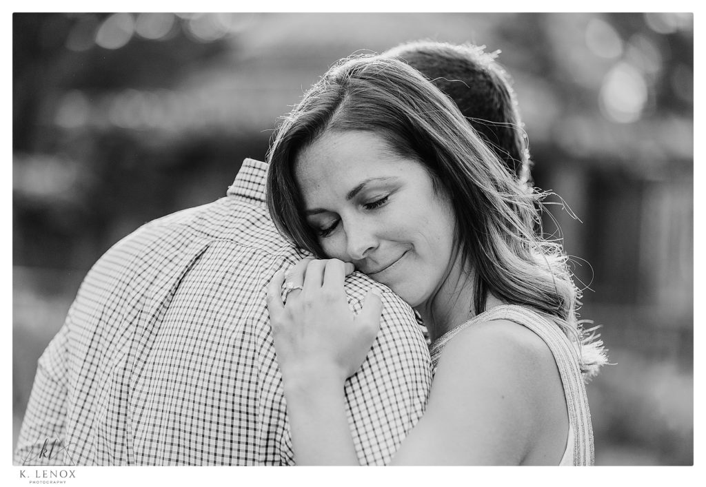 Black and White photo of a man and woman hugging during their engagement session with K. Lenox Photography. 